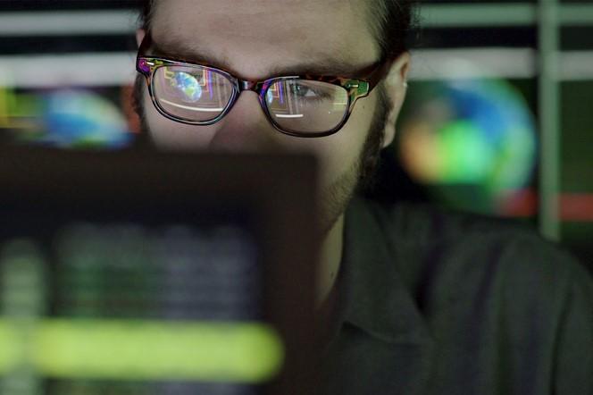 Man glasses computers code.jpg