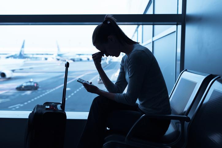 Woman airport upset phone.jpg