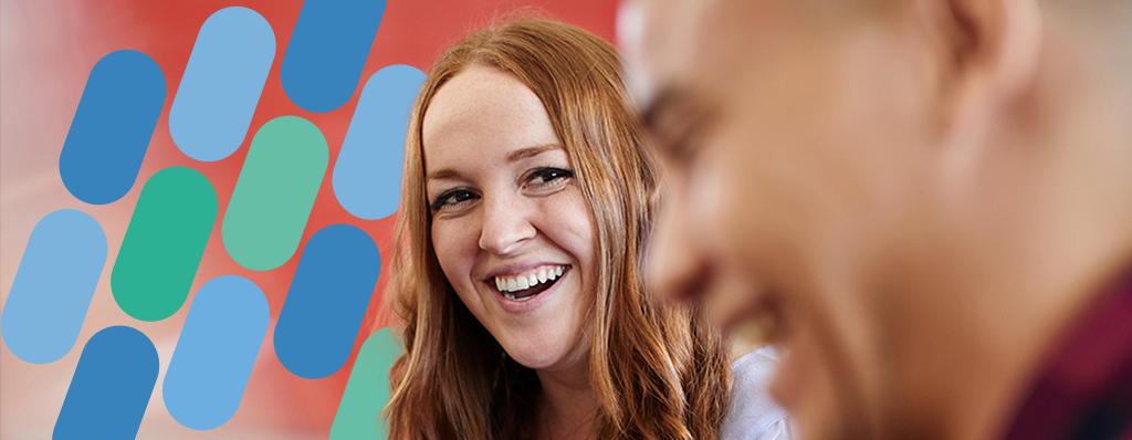 DataIQ Future leaders header. A female red haired DataIQ Future leader laughing