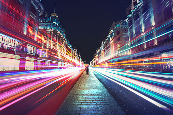 City scene at night with colourful blurred traffic lights